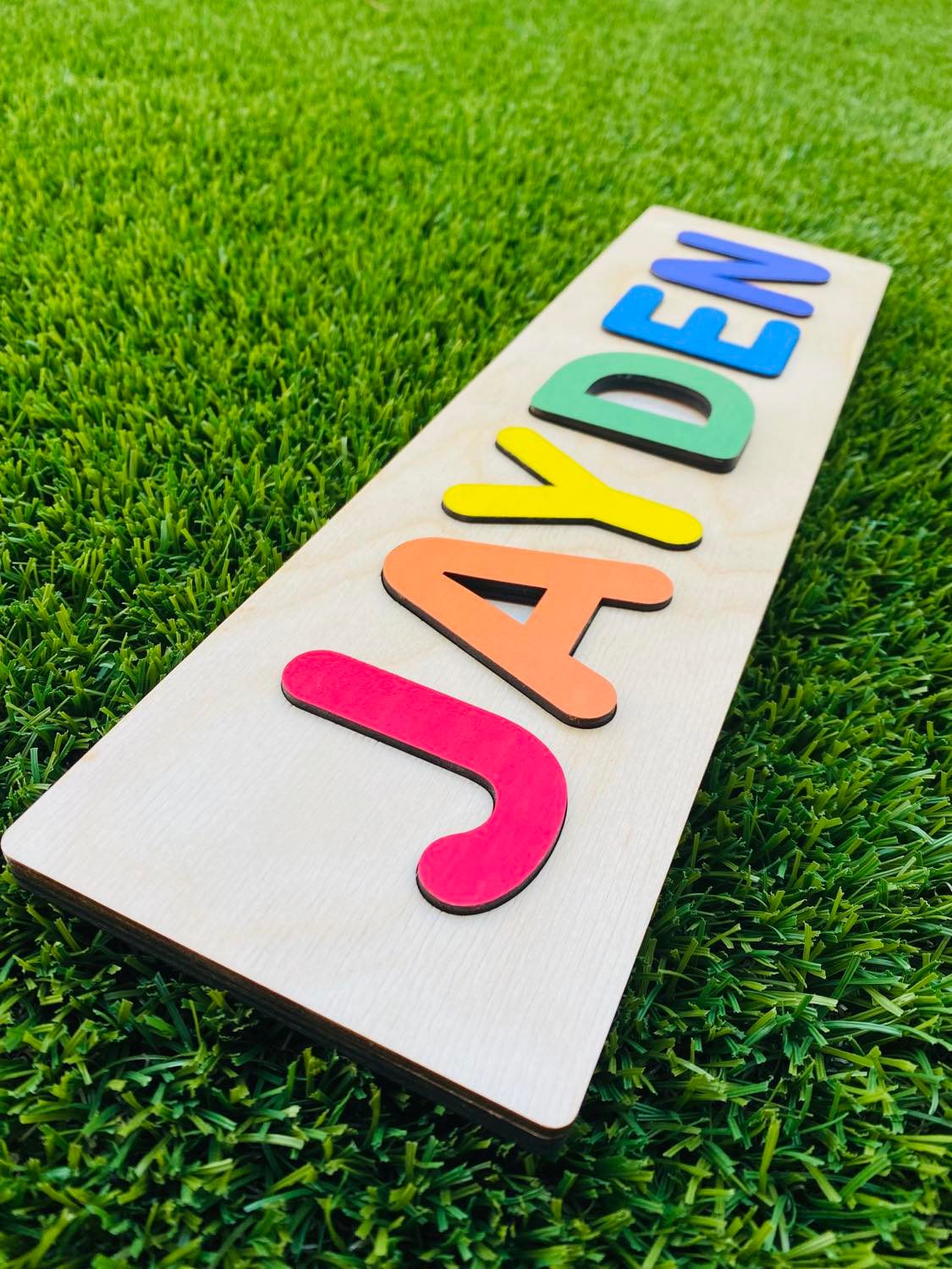 Name Puzzle laying on grass wood letters laser cut