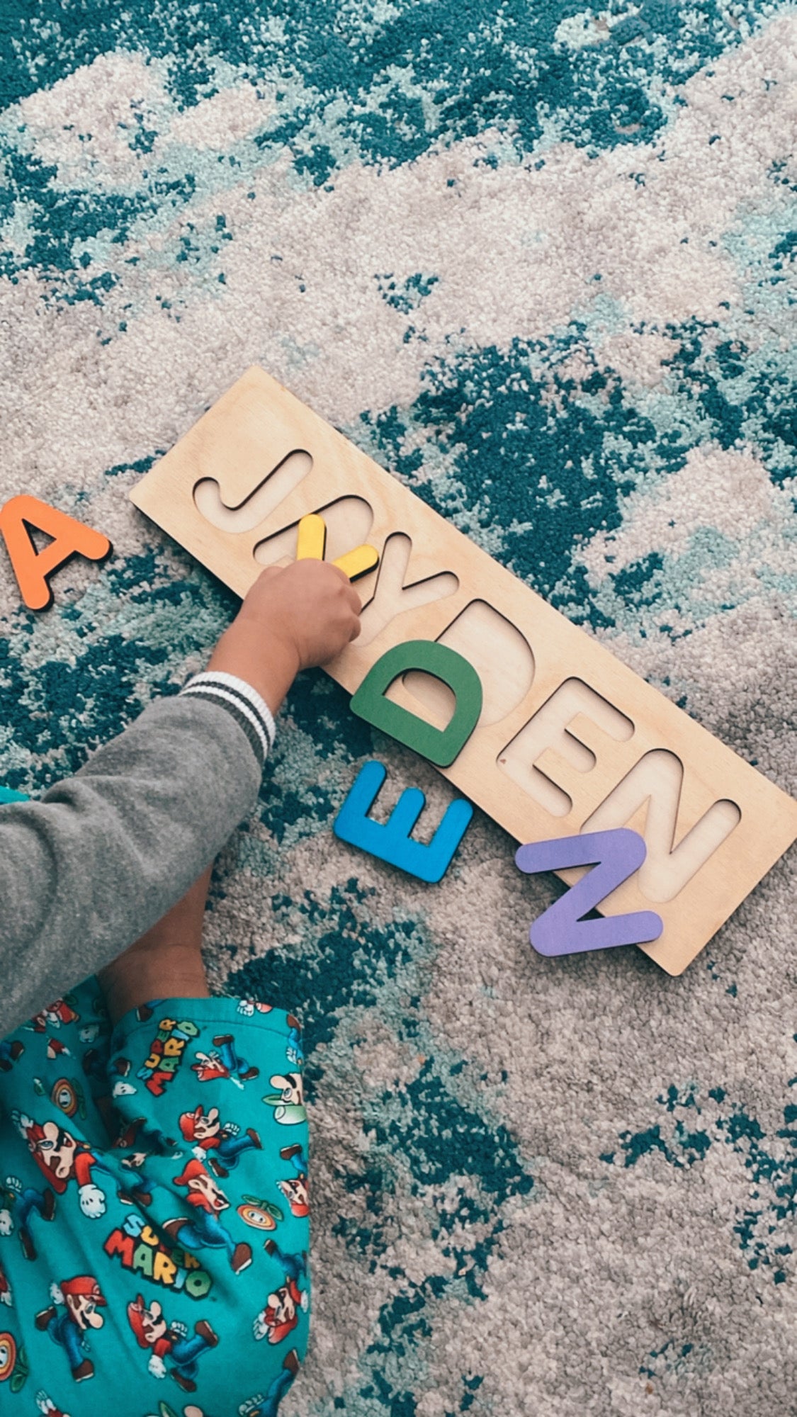 Child playing with name puzzle block letter laser cut wood