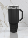 Black travel mug with a silver lid on a marble surface