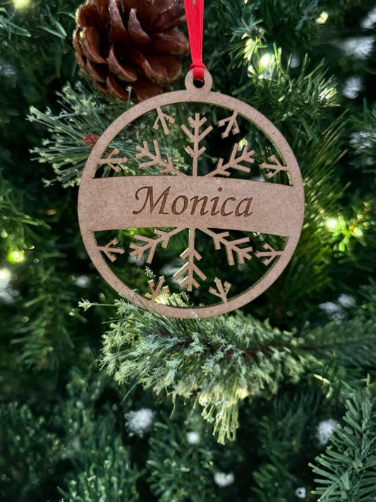 Wooden ornament with 'Monica' engraved on a Christmas tree