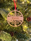Wooden ornament with 'Kevin' engraved on a Christmas tree.